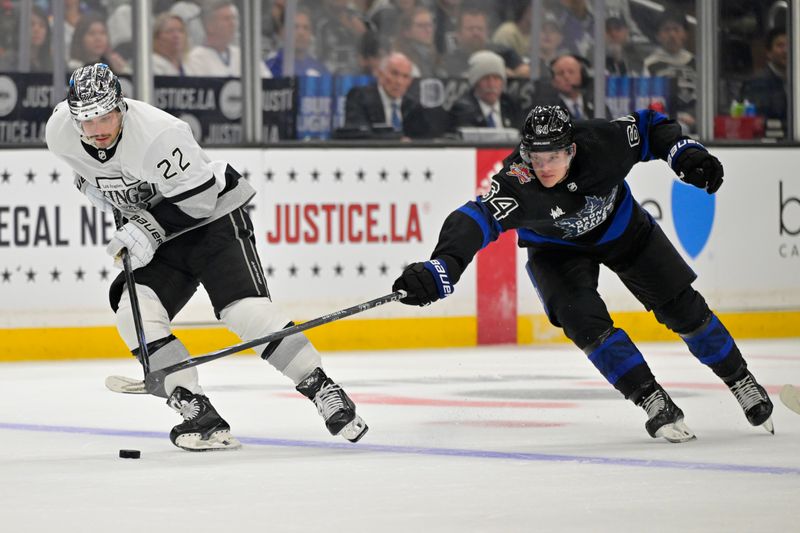 Jan 2, 2024; Los Angeles, California, USA;  Los Angeles Kings left wing Kevin Fiala (22) skates the puck past Toronto Maple Leafs center David Kampf (64) in the second period at Crypto.com Arena. Mandatory Credit: Jayne Kamin-Oncea-USA TODAY Sports