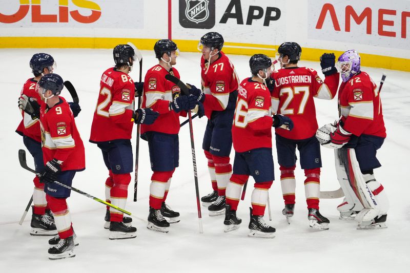 Nov 12, 2023; Sunrise, Florida, USA; Florida Panthers teammates celebrate after defeating the Chicago Blackhawks at Amerant Bank Arena. Mandatory Credit: Jasen Vinlove-USA TODAY Sports