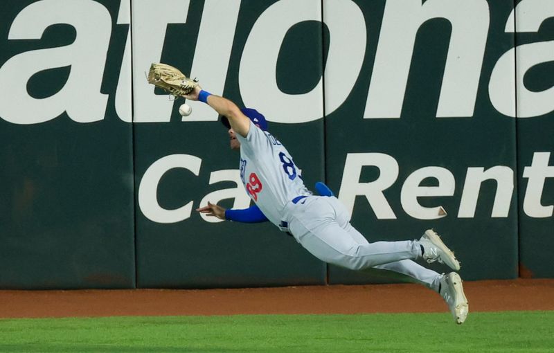 Jul 23, 2023; Arlington, Texas, USA;  Los Angeles Dodgers right fielder Jonny Deluca (89) dives for but cannot make a catch during the first inning against the Texas Rangers at Globe Life Field. Mandatory Credit: Kevin Jairaj-USA TODAY Sports