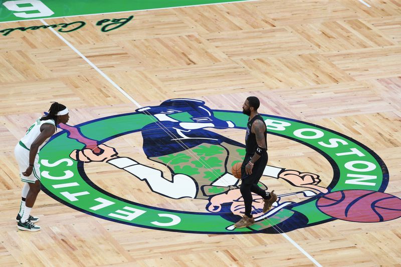 BOSTON, MA - JUNE 6: Kyrie Irving #11 of the Dallas Mavericks handles the ball during the game  against Jrue Holiday #4 of the Boston Celtics during Game 1 of the 2024 NBA Finals on June 6, 2024 at the TD Garden in Boston, Massachusetts. NOTE TO USER: User expressly acknowledges and agrees that, by downloading and or using this photograph, User is consenting to the terms and conditions of the Getty Images License Agreement. Mandatory Copyright Notice: Copyright 2024 NBAE  (Photo by Chris Marion/NBAE via Getty Images)