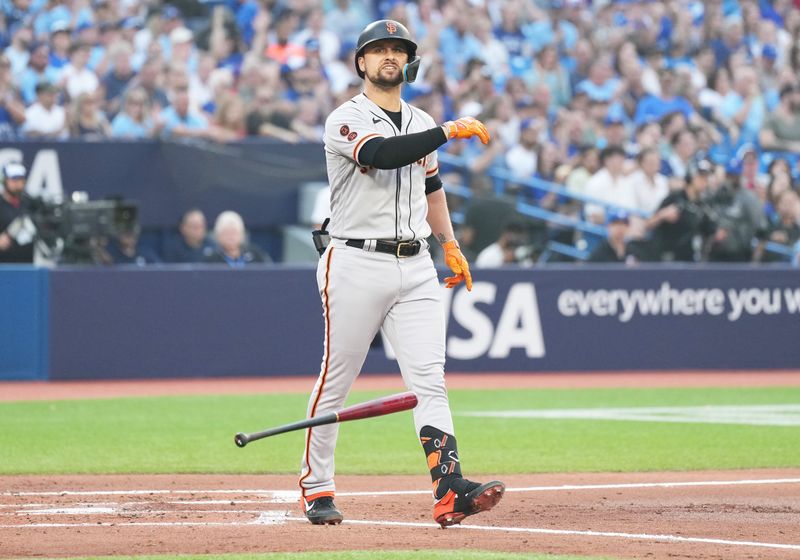 Jun 29, 2023; Toronto, Ontario, CAN; San Francisco Giants third baseman J.D. Davis (7) reacts after being called out on strikes against the Toronto Blue Jays during the third inning at Rogers Centre. Mandatory Credit: Nick Turchiaro-USA TODAY Sports