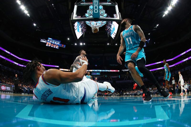 CHARLOTTE, NORTH CAROLINA - JANUARY 29: Jalen Brunson #11 of the New York Knicks is fouled to the ground as his lay up falls through the basket during the second half of the game against the Charlotte Hornets at Spectrum Center on January 29, 2024 in Charlotte, North Carolina. NOTE TO USER: User expressly acknowledges and agrees that, by downloading and or using this photograph, User is consenting to the terms and conditions of the Getty Images License Agreement. (Photo by Jared C. Tilton/Getty Images)