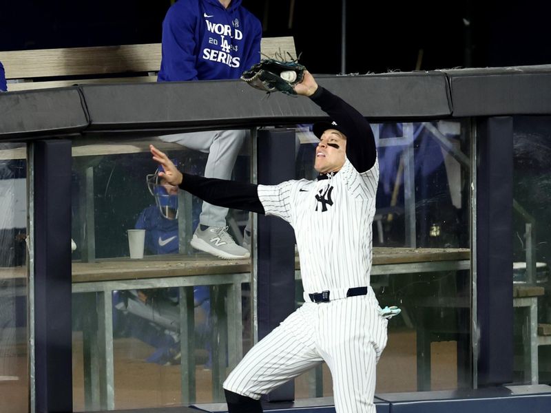 Oct 30, 2024; New York, New York, USA; New York Yankees outfielder Aaron Judge (99) makes a catch during the fourth inning against the Los Angeles Dodgers in game five of the 2024 MLB World Series at Yankee Stadium. Mandatory Credit: Wendell Cruz-Imagn Images