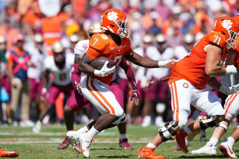 Sep 23, 2023; Clemson, South Carolina, USA; Clemson Tigers running back Phil Mafah (7) runs the ball behind Clemson Tigers offensive lineman Tristan Leigh (71) in the second half against the Florida State Seminoles at Memorial Stadium. Mandatory Credit: David Yeazell-USA TODAY Sports