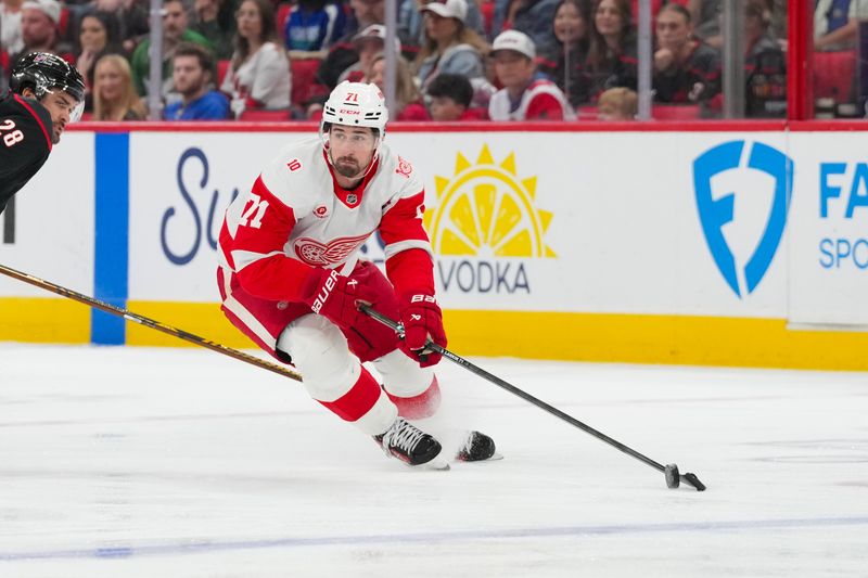 Dec 27, 2025; Raleigh, North Carolina, USA;  Detroit Red Wings center Dylan Larkin (71) skates with the puck against the Carolina Hurricanes during the first period at Lenovo Center. Mandatory Credit: James Guillory-Imagn Images