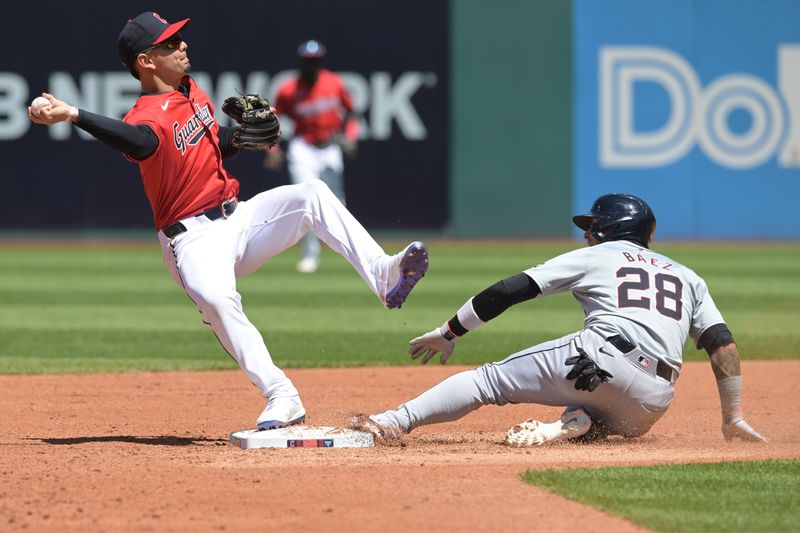 May 8, 2024; Cleveland, Ohio, USA; Cleveland Guardians second baseman Andres Gimenez (0) forces out Detroit Tigers shortstop Javier Baez (28) and attempts to throw for the double play during the third inning at Progressive Field. Mandatory Credit: Ken Blaze-USA TODAY Sports