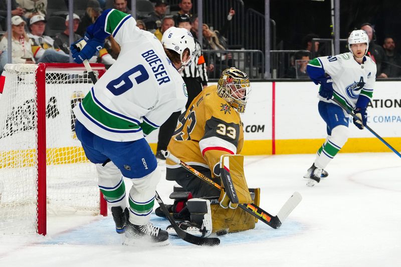 Mar 7, 2024; Las Vegas, Nevada, USA; Vegas Golden Knights goaltender Adin Hill (33) makes a save as Vancouver Canucks right wing Brock Boeser (6) looks for the rebound during the first period at T-Mobile Arena. Mandatory Credit: Stephen R. Sylvanie-USA TODAY Sports