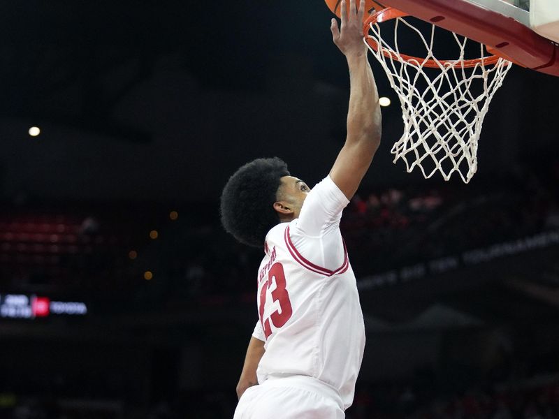 Feb 13, 2024; Madison, Wisconsin, USA;  Wisconsin Badgers guard Chucky Hepburn (23) scores on a breakaway layup during the second half against the Ohio State Buckeyes at the Kohl Center. Mandatory Credit: Kayla Wolf-USA TODAY Sports