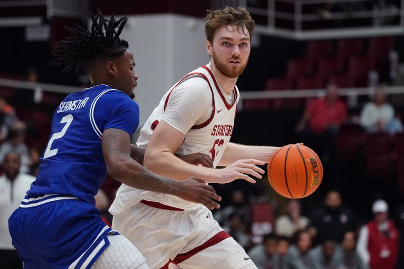 Dec 17, 2025; Stanford, California, USA;  Stanford Cardinal forward/center Aidan Cammann (52) dribbles against Texas-Arlington Mavericks forward Raysean Seamster (2)l in the first half at Maples Pavilion. Mandatory Credit: David Gonzales-Imagn Images