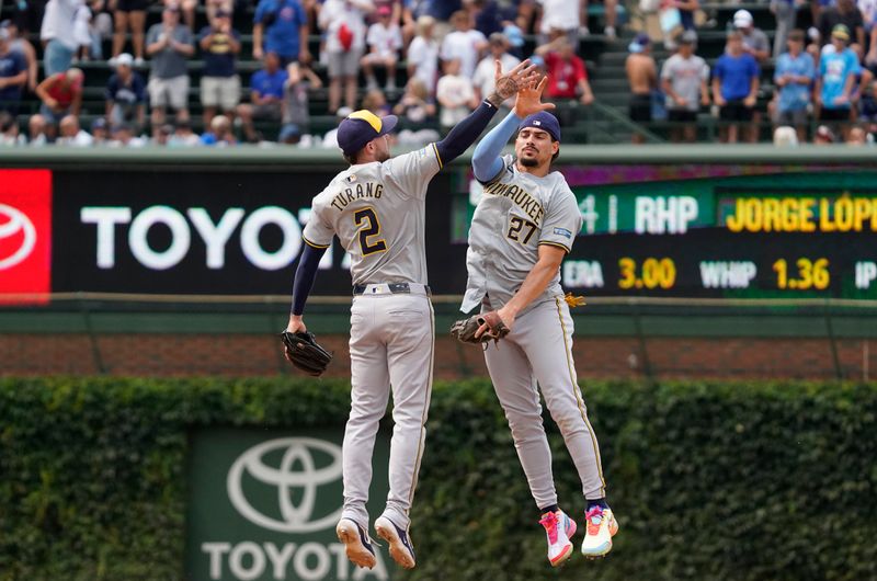 Jul 24, 2024; Chicago, Illinois, USA; Milwaukee Brewers shortstop Willy Adames (27) and second baseman Brice Turang (2) celebrate after defeating the Chicago Cubs at Wrigley Field. Mandatory Credit: David Banks-USA TODAY Sports