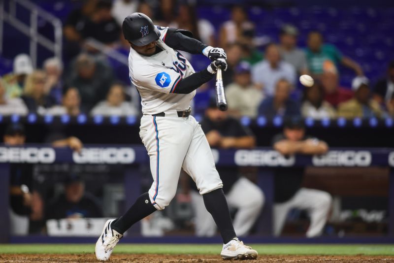 Aug 20, 2024; Miami, Florida, USA; Miami Marlins shortstop Xavier Edwards (63) hits an RBI single against the Arizona Diamondbacks during the fifth inning at loanDepot Park. Mandatory Credit: Sam Navarro-USA TODAY Sports