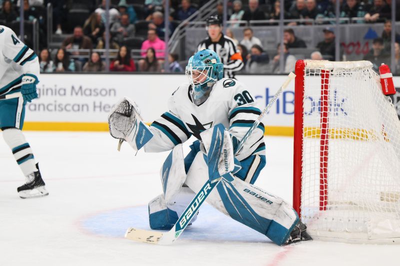 Jan 30, 2025; Seattle, Washington, USA; San Jose Sharks goaltender Yaroslav Askarov (30) defends the goal against the Seattle Kraken during the first period at Climate Pledge Arena. Mandatory Credit: Steven Bisig-Imagn Images