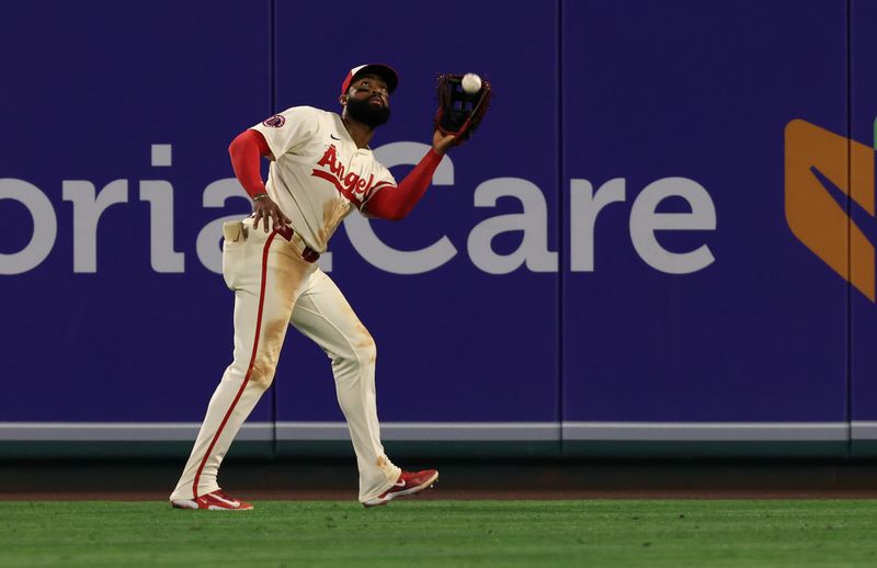 Jun 6, 2025; Anaheim, California, USA; Los Angeles Angels outfielder Jo Adell (7) makes a catch during the ninth inning against the Seattle Mariners at Angel Stadium. Mandatory Credit: Jason Parkhurst-Imagn Images