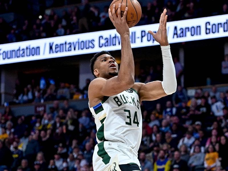 DENVER, CO - MARCH 25:  Giannis Antetokounmpo #34 of the Milwaukee Bucks shoots a layup against the Denver Nuggets in the second half of a game at Ball Arena on March 25, 2023 in Denver, Colorado. NOTE TO USER: User expressly acknowledges and agrees that, by downloading and or using this photograph, User is consenting to the terms and conditions of the Getty Images License Agreement. (Photo by Dustin Bradford/Getty Images)