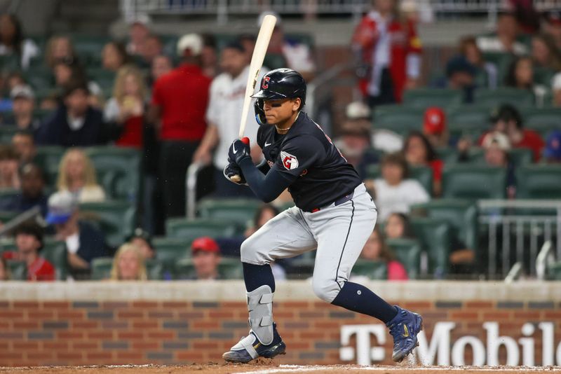 Apr 27, 2024; Atlanta, Georgia, USA; Cleveland Guardians catcher Bo Naylor (23) hits a single against the Atlanta Braves in the eighth inning at Truist Park. Mandatory Credit: Brett Davis-USA TODAY Sports
