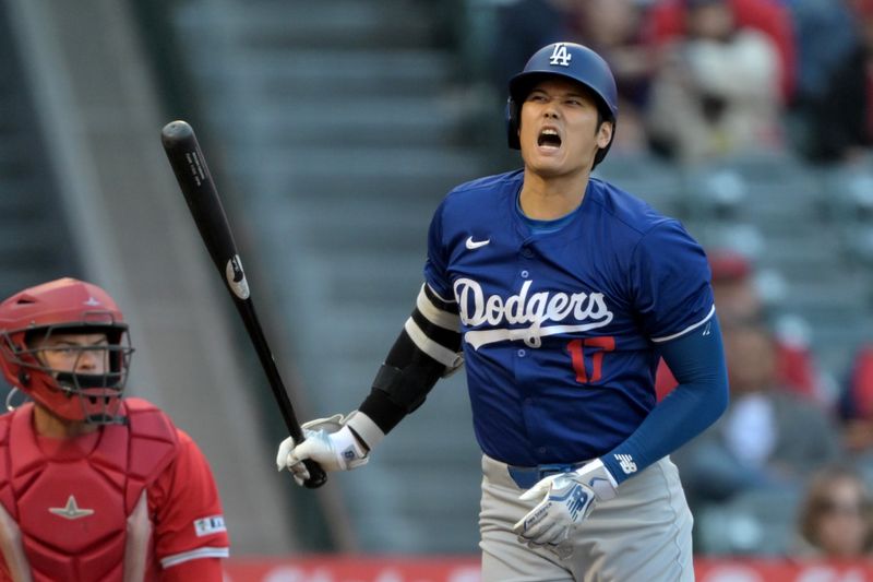 Mar 26, 2024; Anaheim, California, USA; Los Angeles Dodgers designated hitter Shohei Ohtani (17) reacts after fouling off a pitch in the first inning against the Los Angeles Angels at Angel Stadium. Mandatory Credit: Jayne Kamin-Oncea-USA TODAY Sports