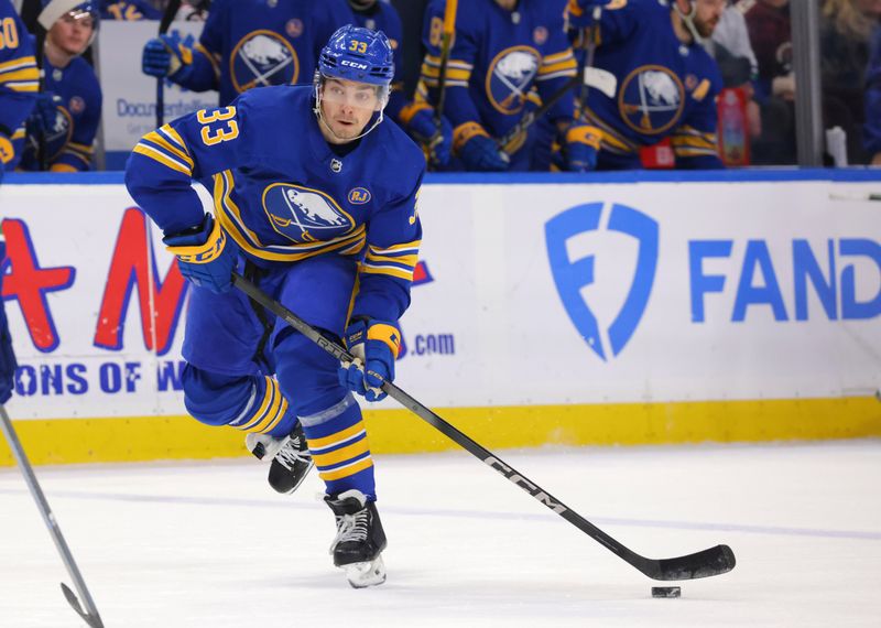 Jan 13, 2024; Buffalo, New York, USA;  Buffalo Sabres defenseman Ryan Johnson (33) skates up ice with the puck during the second period against the Vancouver Canucks at KeyBank Center. Mandatory Credit: Timothy T. Ludwig-USA TODAY Sports