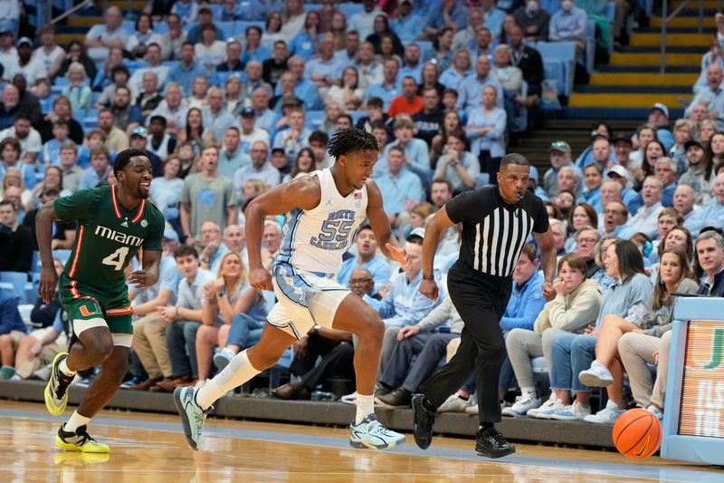 Feb 26, 2024; Chapel Hill, North Carolina, USA; North Carolina Tar Heels forward Harrison Ingram (55) chases the ball as Miami (Fl) Hurricanes guard Bensley Joseph (4) looks on in the second half at Dean E. Smith Center. Mandatory Credit: Bob Donnan-USA TODAY Sports