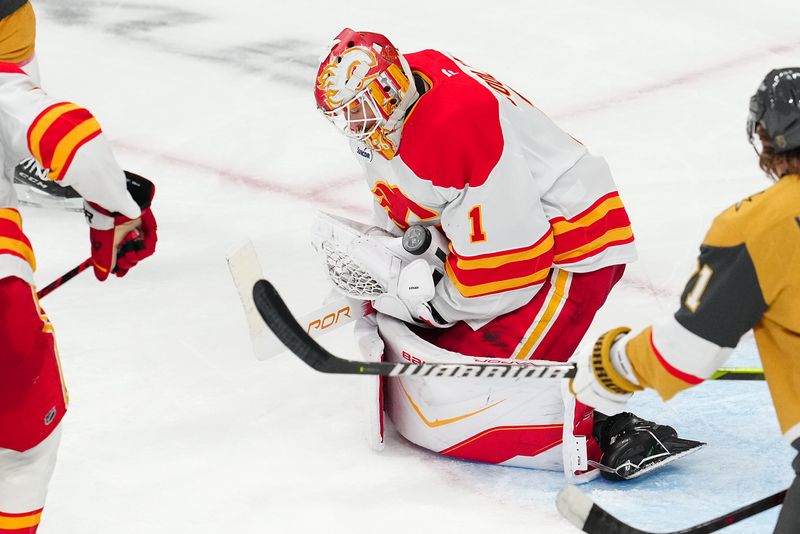 Oct 18, 2025; Las Vegas, Nevada, USA; Calgary Flames goaltender Devin Cooley (1) makes a save against the Vegas Golden Knights during the third period at T-Mobile Arena. Mandatory Credit: Stephen R. Sylvanie-Imagn Images