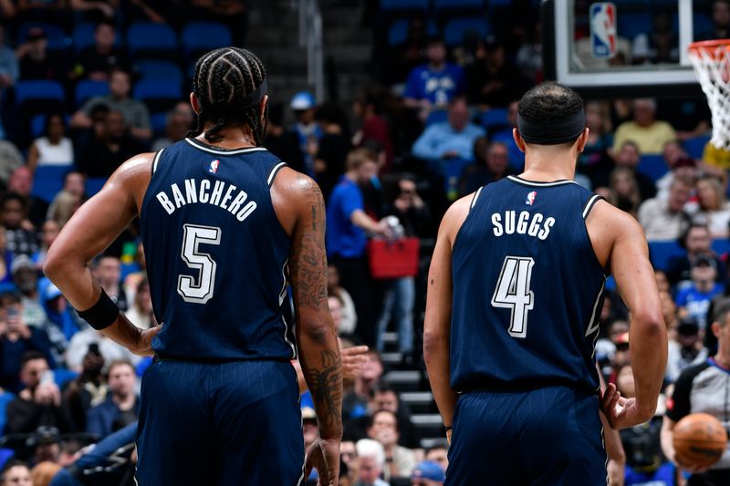 ORLANDO, FL - MARCH 21: Paolo Banchero #5 and Jalen Suggs #4 of the Orlando Magic looks on during the game against the New Orleans Pelicans on March 21, 2024 at Amway Center in Orlando, Florida. NOTE TO USER: User expressly acknowledges and agrees that, by downloading and or using this photograph, User is consenting to the terms and conditions of the Getty Images License Agreement. Mandatory Copyright Notice: Copyright 2024 NBAE (Photo by Fernando Medina/NBAE via Getty Images)