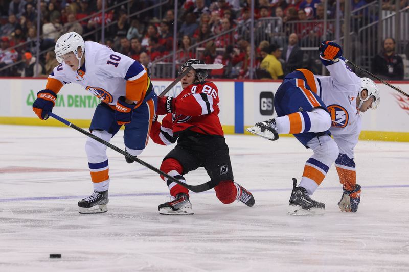 Oct 25, 2024; Newark, New Jersey, USA; New Jersey Devils center Jack Hughes (86) is hit by New York Islanders defenseman Alexander Romanov (28) during the second period at Prudential Center. Mandatory Credit: Ed Mulholland-Imagn Images