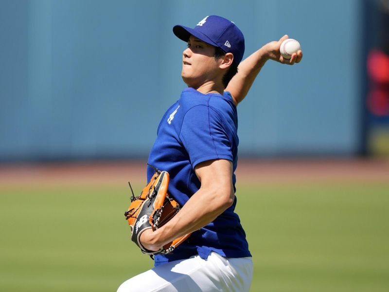 Jun 15, 2024; Los Angeles, California, USA; Los Angeles Dodgers player Shohei Ohtani throws before the game against the Kansas City Royals at Dodger Stadium. Mandatory Credit: Kirby Lee-USA TODAY Sports