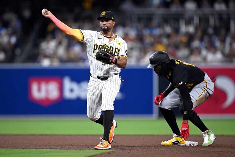 Aug 13, 2024; San Diego, California, USA; San Diego Padres second baseman Xander Bogaerts (2) throws to first base after forcing out Pittsburgh Pirates shortstop Oneil Cruz (15) at second base to complete a double play during the sixth inning at Petco Park. Mandatory Credit: Orlando Ramirez-USA TODAY Sports