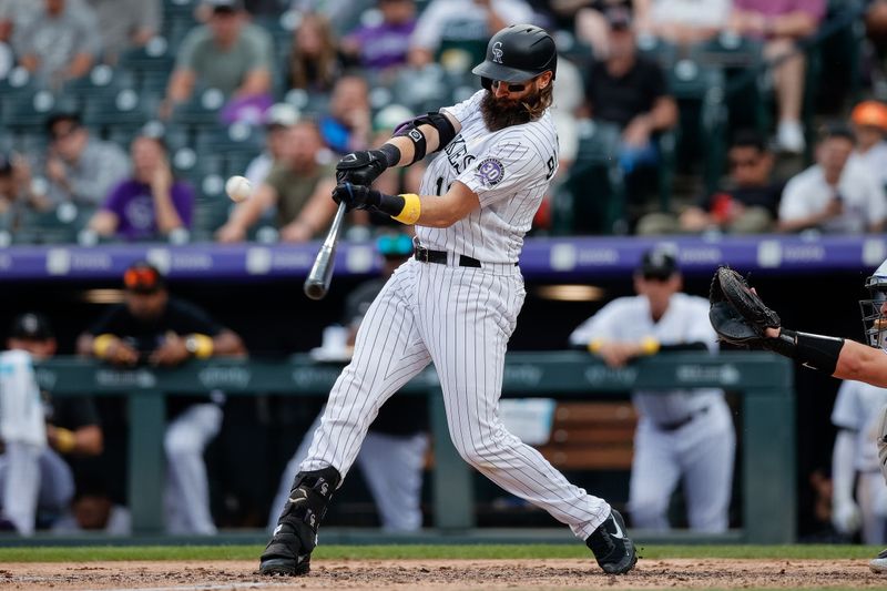 Sep 3, 2023; Denver, Colorado, USA; Colorado Rockies designated hitter Charlie Blackmon (19) hits a single in the sixth inning against the Toronto Blue Jays at Coors Field. Mandatory Credit: Isaiah J. Downing-USA TODAY Sports