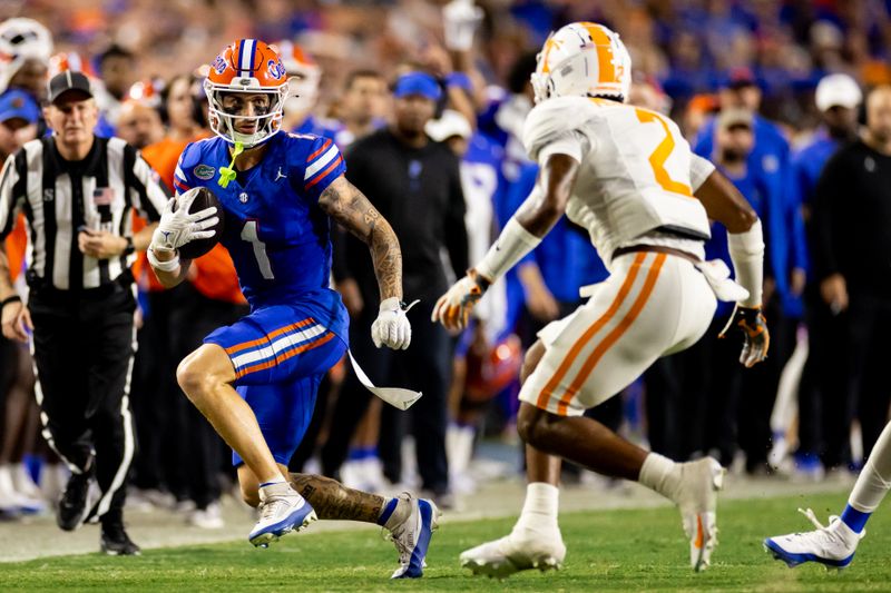 Sep 16, 2023; Gainesville, Florida, USA; Florida Gators wide receiver Ricky Pearsall (1) runs away from Tennessee Volunteers defensive back Jaylen McCollough (2) during the first half at Ben Hill Griffin Stadium. Mandatory Credit: Matt Pendleton-USA TODAY Sports