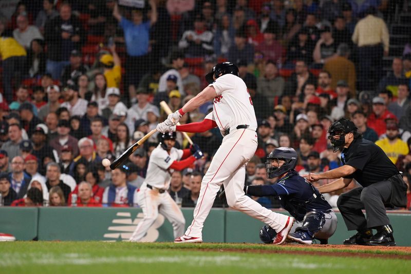 May 15, 2024; Boston, Massachusetts, USA; Boston Red Sox first baseman Garrett Cooper (28) hits a single against the Tampa Bay Rays during the sixth inning at Fenway Park. Mandatory Credit: Eric Canha-USA TODAY Sports