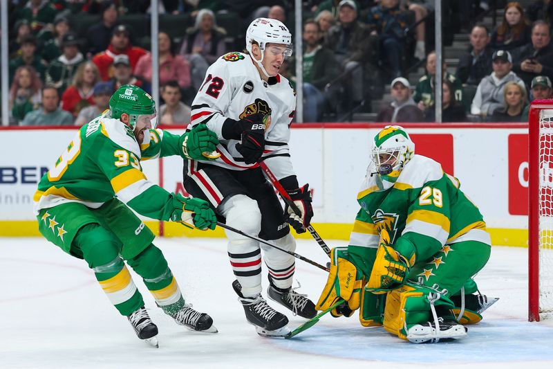 Dec 3, 2023; Saint Paul, Minnesota, USA; Minnesota Wild goaltender Marc-Andre Fleury (29) blocks a shot by Chicago Blackhawks defenseman Alex Vlasic (72) while Minnesota Wild defenseman Alex Goligoski (33) defends during the first period at Xcel Energy Center. Mandatory Credit: Matt Krohn-USA TODAY Sports