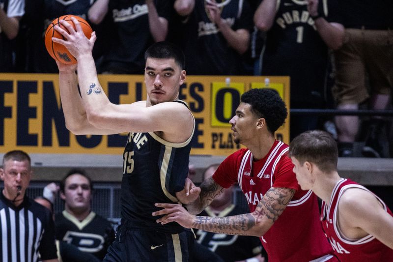 Feb 10, 2024; West Lafayette, Indiana, USA; Purdue Boilermakers center Zach Edey (15) holds the ball while Indiana Hoosiers center Kel'el Ware (1) defends in the first half at Mackey Arena. Mandatory Credit: Trevor Ruszkowski-USA TODAY Sports