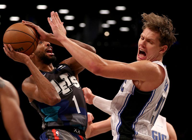 NEW YORK, NEW YORK - DECEMBER 02: Mikal Bridges #1 of the Brooklyn Nets heads for the net as Moritz Wagner #21 of the Orlando Magic defends during the first half at Barclays Center on December 02, 2023 in New York City. NOTE TO USER: User expressly acknowledges and agrees that, by downloading and or using this photograph, User is consenting to the terms and conditions of the Getty Images License Agreement. (Photo by Elsa/Getty Images)