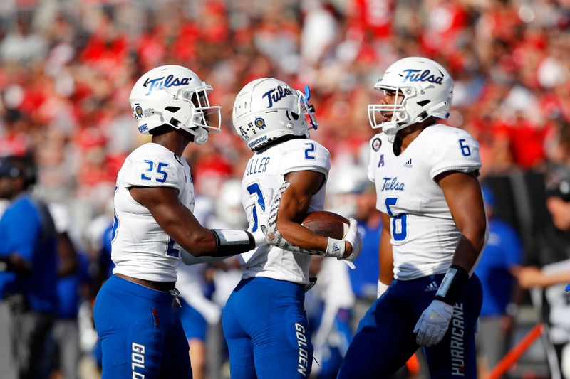 Sep 18, 2021; Columbus, Ohio, USA; Tulsa Golden Hurricane cornerback Travon Fuller (2) celebrates his interception with linebacker Jordan Ford (6) and safety Jaise Oliver (25) during the second quarter against the Ohio State Buckeyes at Ohio Stadium. Mandatory Credit: Joseph Maiorana-USA TODAY Sports