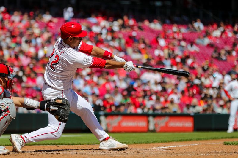 Apr 25, 2024; Cincinnati, Ohio, USA; Cincinnati Reds catcher Luke Maile (22) hits a single against the Philadelphia Phillies in the eighth inning at Great American Ball Park. Mandatory Credit: Katie Stratman-USA TODAY Sports
