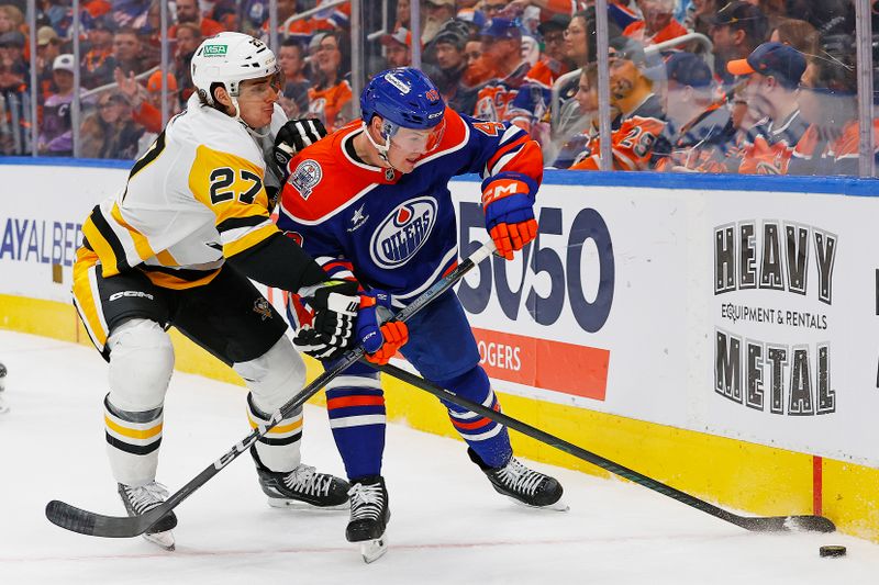 Oct 25, 2024; Edmonton, Alberta, CAN; Pittsburgh Penguins defensemen Ryan Graves (27) and Edmonton Oilers defensemen Ty Emberson (49) battle along the boards for a loose puck during the third period at Rogers Place. Mandatory Credit: Perry Nelson-Imagn Images