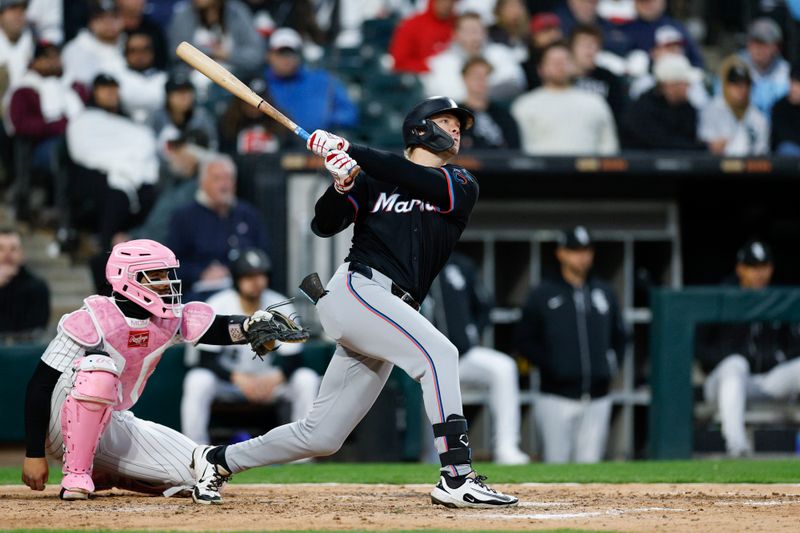 May 10, 2025; Chicago, Illinois, USA; Miami Marlins left fielder Kyle Stowers (28) hits a solo home run against the Chicago White Sox during the seventh inning at Rate Field. Mandatory Credit: Kamil Krzaczynski-Imagn Images