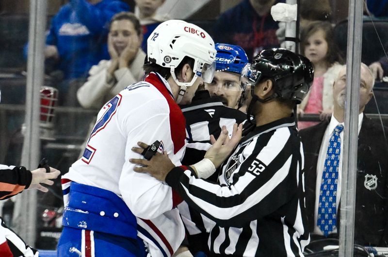 Nov 30, 2024; New York, New York, USA; Linesman Shandor Alphonso (52) breaks up a fight between Montreal Canadiens defenseman Arber Xhekaj (72) and New York Rangers center Sam Carrick (39) during the second period at Madison Square Garden. Mandatory Credit: John Jones-Imagn Images