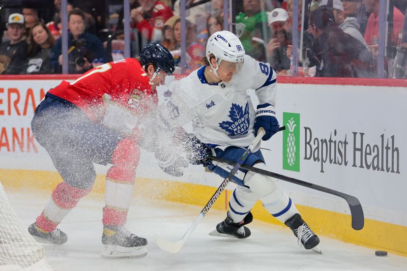 Apr 8, 2025; Sunrise, Florida, USA; Toronto Maple Leafs right wing William Nylander (88) moves the puck past Florida Panthers defenseman Niko Mikkola (77) during the third period at Amerant Bank Arena. Mandatory Credit: Sam Navarro-Imagn Images