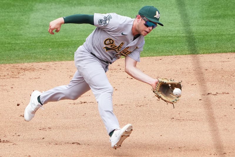 Jul 30, 2023; Denver, Colorado, USA; Oakland Athletics shortstop Nick Allen (2) fields the ball in the fifth inning against the Colorado Rockies at Coors Field. Mandatory Credit: Ron Chenoy-USA TODAY Sports