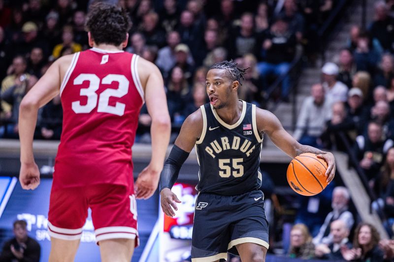 Feb 10, 2024; West Lafayette, Indiana, USA; Purdue Boilermakers guard Lance Jones (55) dribbles the ball while Indiana Hoosiers guard Trey Galloway (32) defends in the second half at Mackey Arena. Mandatory Credit: Trevor Ruszkowski-USA TODAY Sports