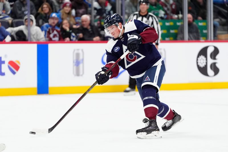 Jan 20, 2025; Denver, Colorado, USA; Colorado Avalanche defenseman Cale Makar (8) shoots the puck in the second period against the Minnesota Wild at Ball Arena. Mandatory Credit: Ron Chenoy-Imagn Images