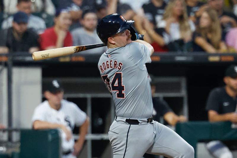 Aug 24, 2024; Chicago, Illinois, USA; Detroit Tigers catcher Jake Rogers (34) hits a two-run single against the Chicago White Sox during the fourth inning at Guaranteed Rate Field. Mandatory Credit: Kamil Krzaczynski-USA TODAY Sports