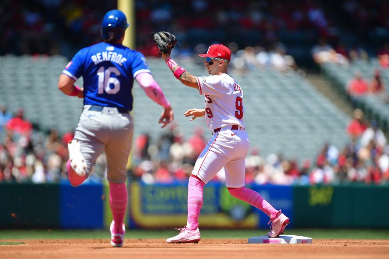 May 12, 2024; Anaheim, California, USA; Los Angeles Angels shortstop Zach Neto (9) tags second for the out against Kansas City Royals right fielder Hunter Renfroe (16) during the second inning at Angel Stadium. Mandatory Credit: Gary A. Vasquez-USA TODAY Sports