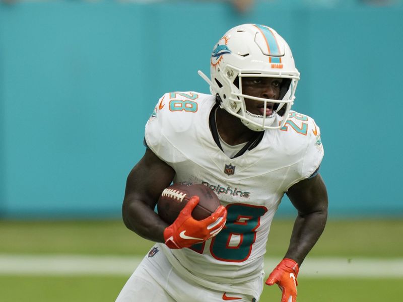 Miami Dolphins running back De'Von Achane (28) runs a play during the second half of an NFL football game against the New York Giants, Sunday, Oct. 8, 2023, in Miami Gardens, Fla. (AP Photo/Wilfredo Lee)