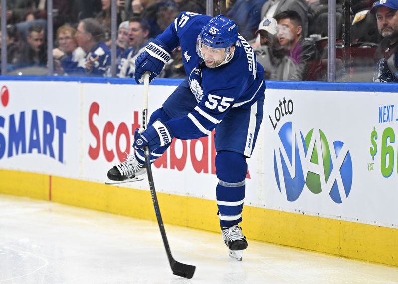 Jan 17, 2023; Toronto, Ontario, CAN;   Toronto Maple Leafs defenseman Mark Giordano (55) clears the puck against the Florida Panthers in the second period at Scotiabank Arena. Mandatory Credit: Dan Hamilton-USA TODAY Sports