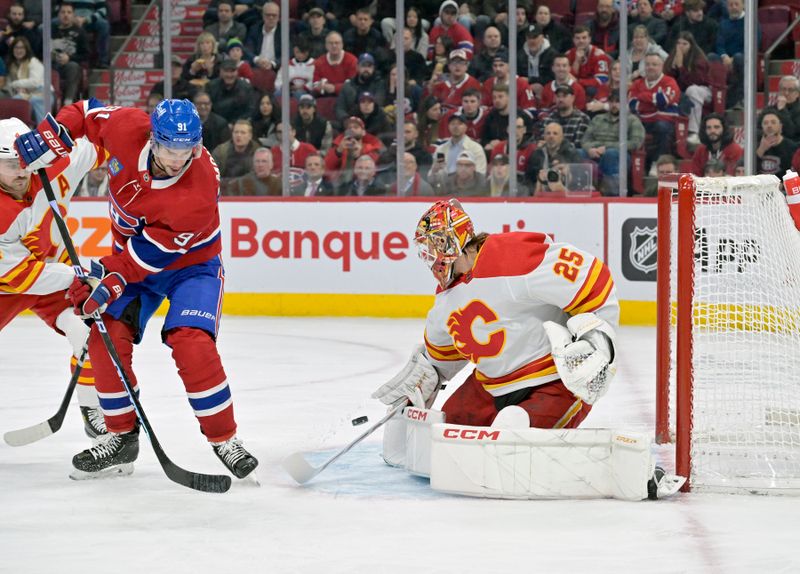 Nov 14, 2023; Montreal, Quebec, CAN; Calgary Flames goalie Jacob Markstrom (25) stops Montreal Canadiens forward Sean Monahan (91) during the first period at the Bell Centre. Mandatory Credit: Eric Bolte-USA TODAY Sports