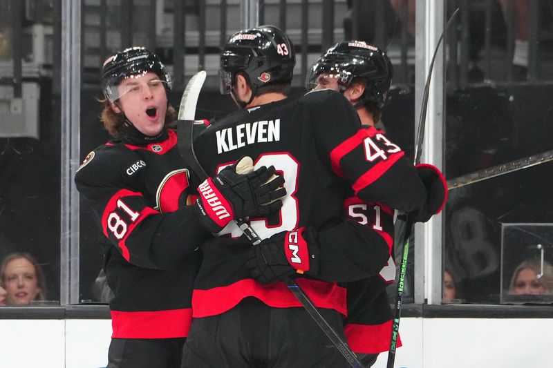 Oct 25, 2024; Las Vegas, Nevada, USA; Ottawa Senators right wing Adam Gaudette (81) celebrates with Ottawa Senators defenseman Tyler Kleven (43) and Ottawa Senators left wing Cole Reinhardt (51) after scoring a goal against the Vegas Golden Knights during the first period at T-Mobile Arena. Mandatory Credit: Stephen R. Sylvanie-Imagn Images