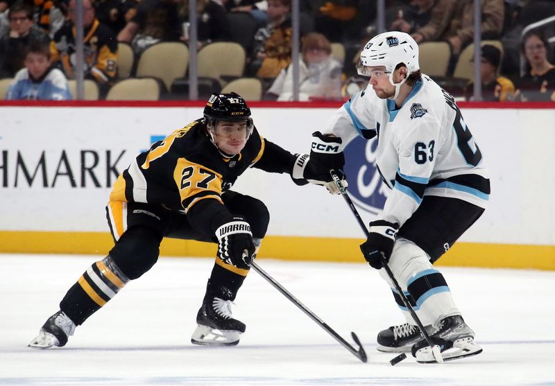 Nov 23, 2024; Pittsburgh, Pennsylvania, USA;  Utah Hockey Club left wing Matias Maccelli (63) skates with the puck against Pittsburgh Penguins defenseman Ryan Graves (27) during the third period at PPG Paints Arena. Mandatory Credit: Charles LeClaire-Imagn Images