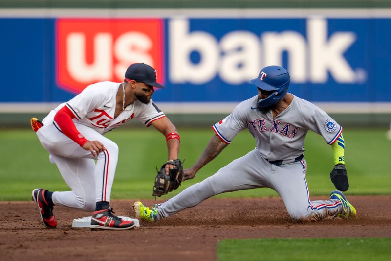 Jun 10, 2025; Minneapolis, Minnesota, USA; Texas Rangers right fielder Adolis Garcia (53) slides into second base before Minnesota Twins second baseman Willi Castro (50) can make a tag in the second inning for a successful stolen base at Target Field. Mandatory Credit: Jesse Johnson-Imagn Images